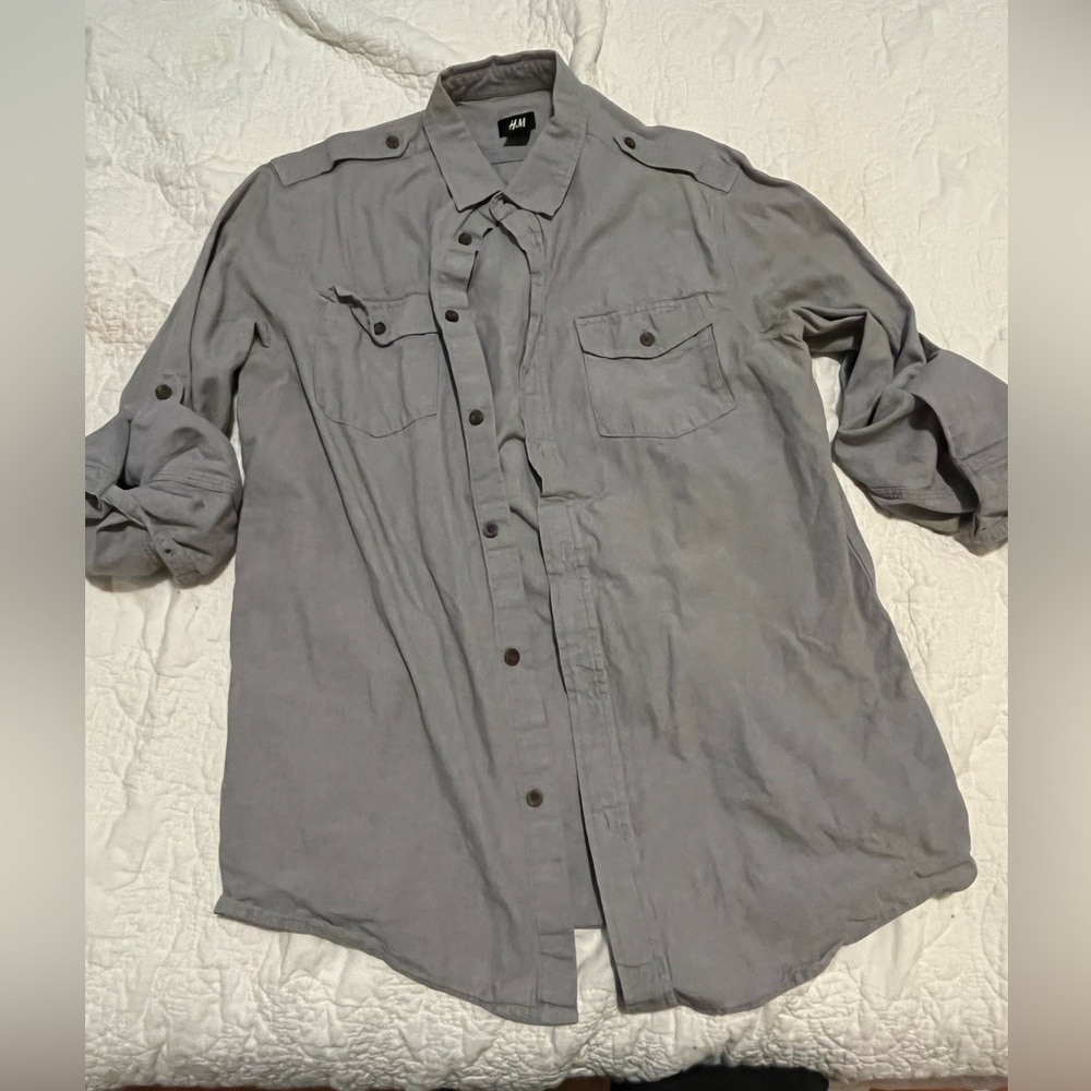 Medium gray H&M button up with sleeve button hangs.